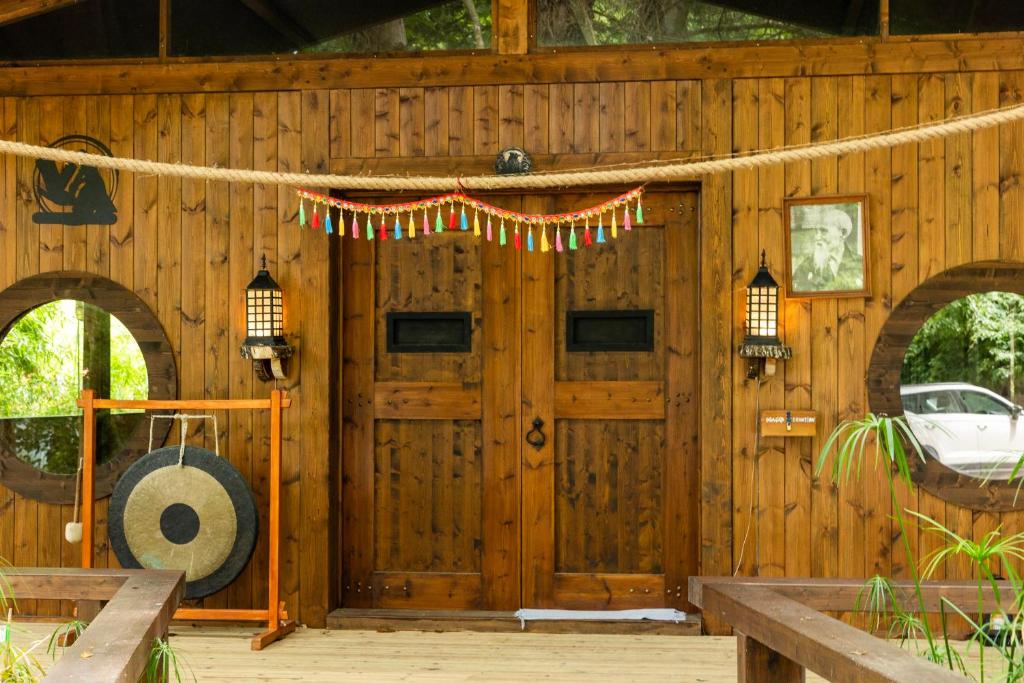 Entrada do dojo com portas em madeira e gongo