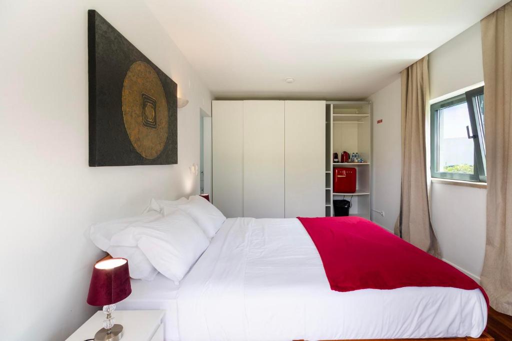 Cama de casal com janela lateral e roupeiros
